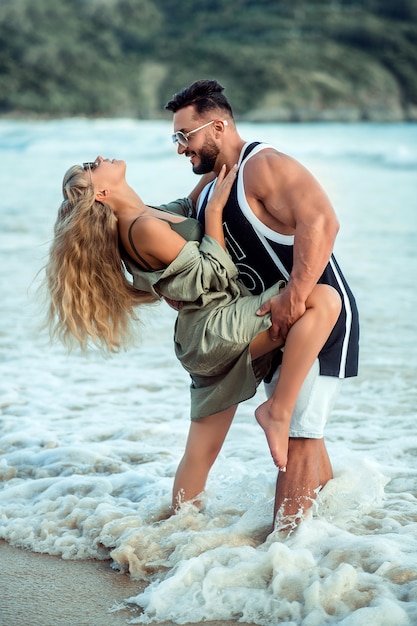 Young couple cuddling on the beach