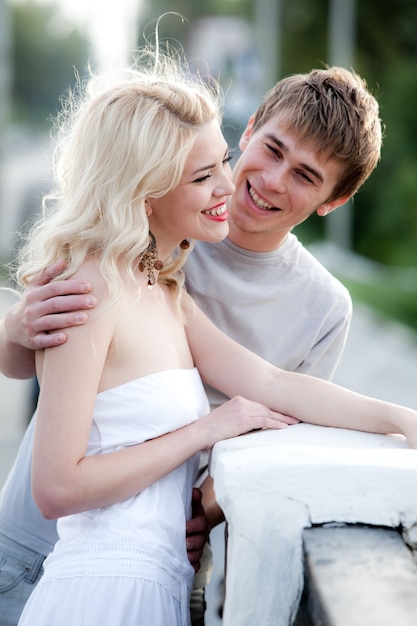 Young couple cuddling while walking in love