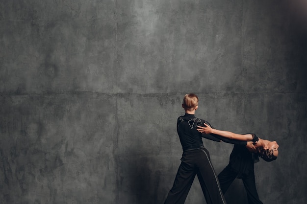 Young couple dancing in ballroom dance Paso doble.