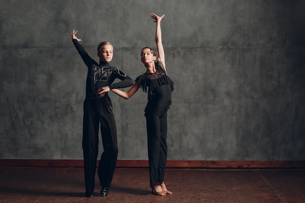 Photo young couple dancing in ballroom dance paso doble.