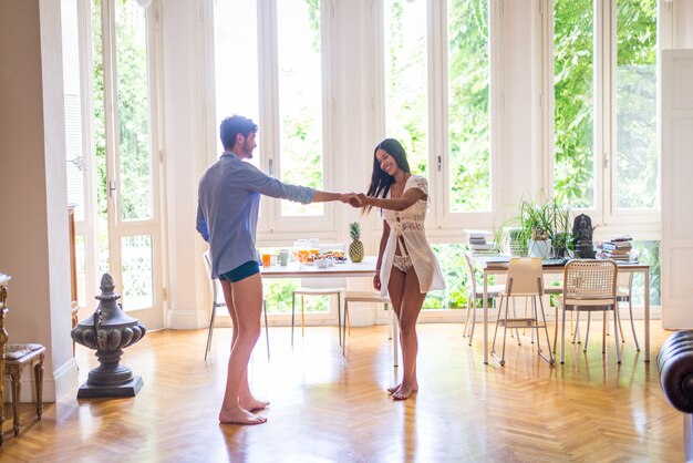 Young couple dancing at home