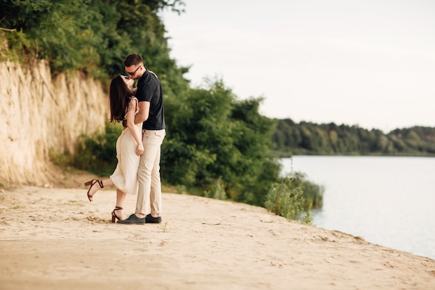 Young couple dancing and kissing at beach