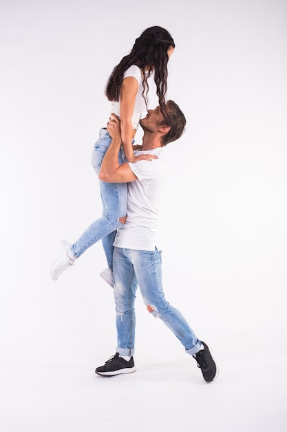 Young couple dancing social latin dance bachata, merengue,\
salsa. two elegance pose on white background.
