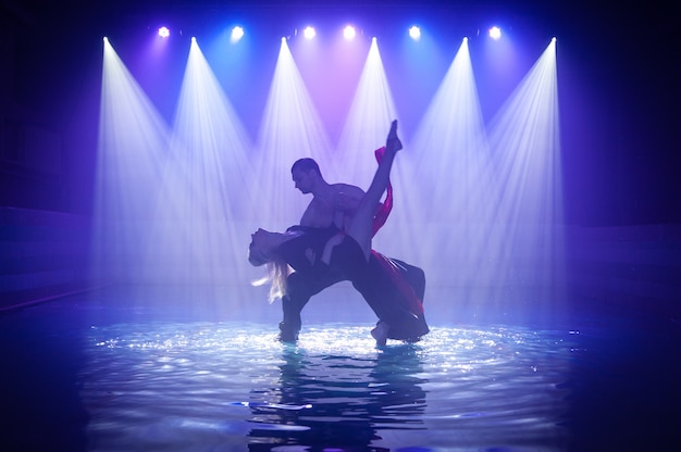 Young couple dancing in the water