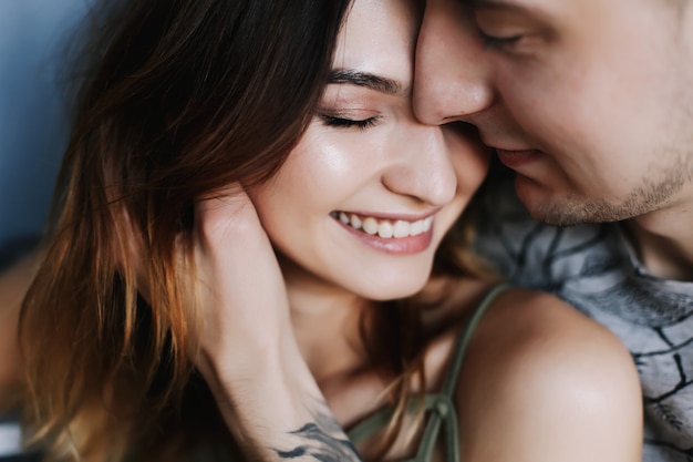 Photo young couple deeply in love hugging and kissing. valentines day, love, romantic, family concept