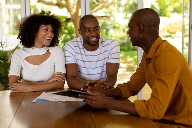 Young couple discussing with a financial adviser