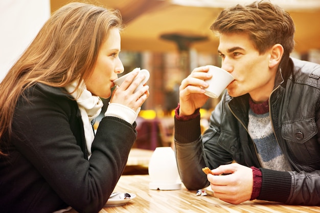 a young couple drinking coffee in a restaurant