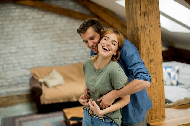 Young couple embracing each other at home