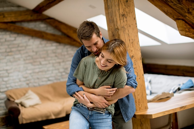 Young couple embracing each other at home