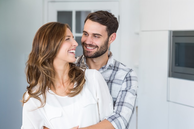 Young couple embracing at home