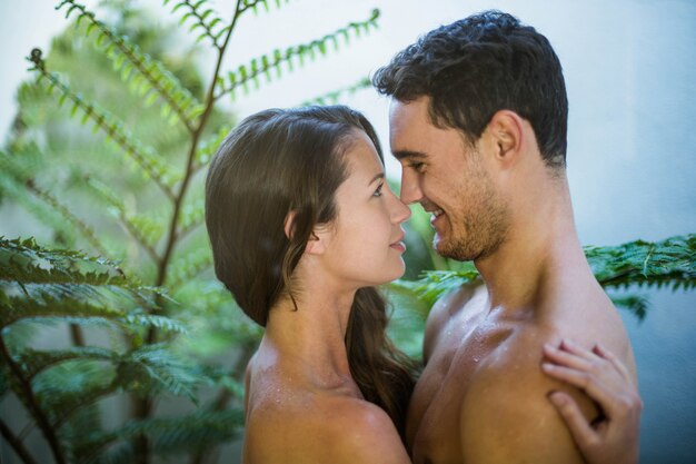 Young couple embracing passionately in garden