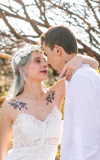 Young couple embracing while standing outdoors