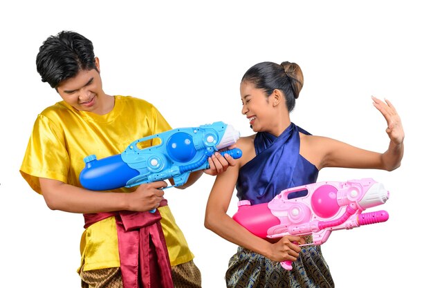 young couple enjoy with water gun on songkran festival