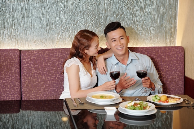 young couple enjoying good wine and converation in fancy restaurant