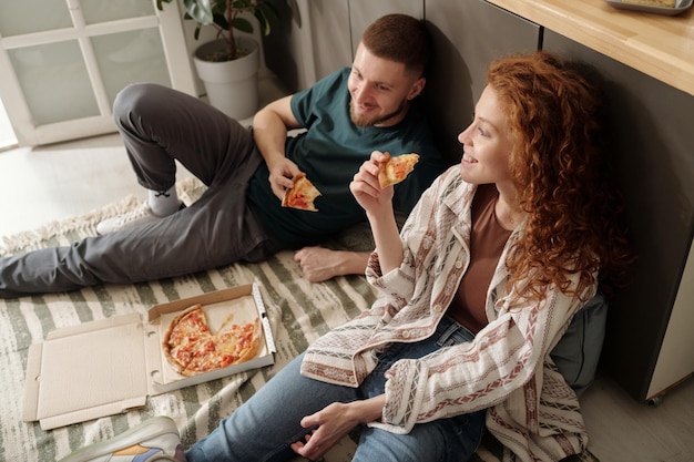 Young couple enjoying lunch on the floor