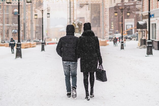 Young couple enjoying walk in city streets in winter season