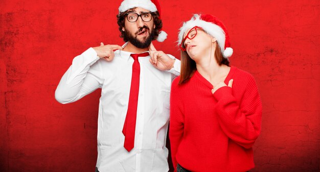 Young couple expressing christmas concept. couple and background in different layers