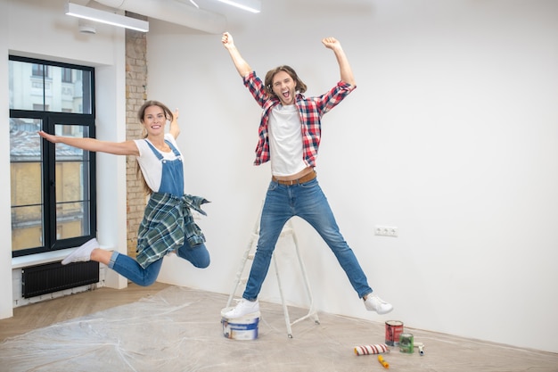 Young couple feeling great and jumping in the air