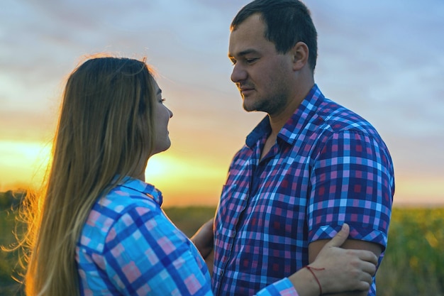 Young couple in a field of sunflowers pregnant girl in sunflowers