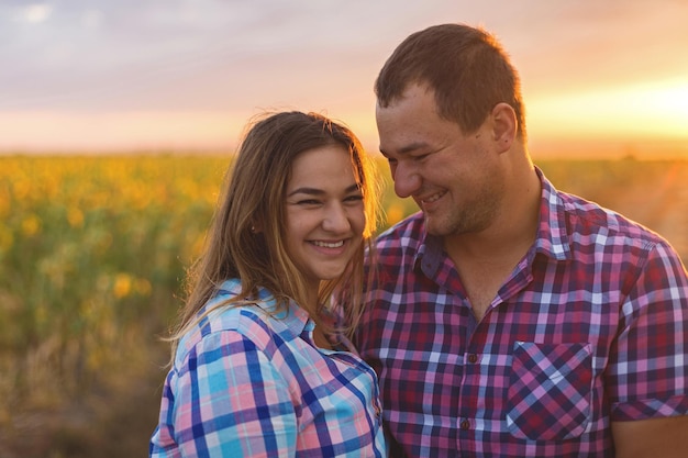 Young couple in a field of sunflowers pregnant girl in sunflowers