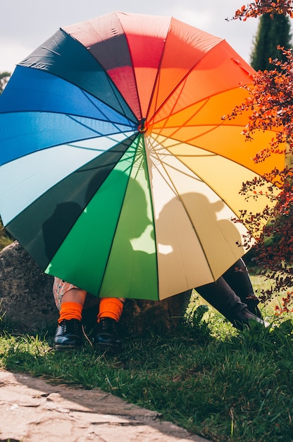  young couple of girls. Girls in love with lgbt umbrella.