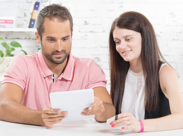 A young couple go shopping on internet