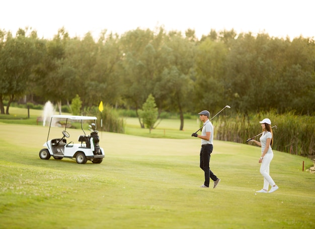 Young couple at golf cart