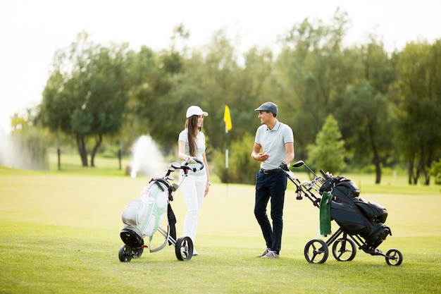 Young couple at golf cart