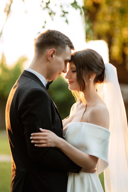 Young couple the groom in a black suit and the bride in a white short dress