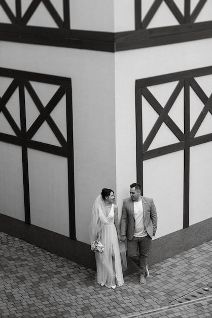 Young couple the groom in and the bride on a walk