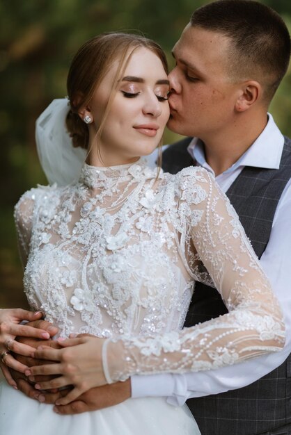 Young couple the groom in a plaid suit and the bride in a chic white dress