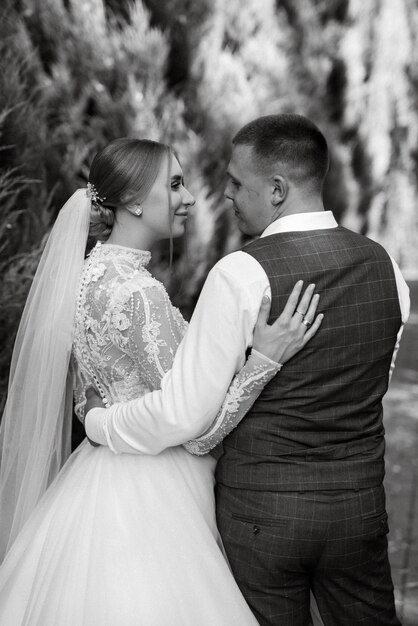 Young couple the groom in a plaid suit and the bride in a chic white dress