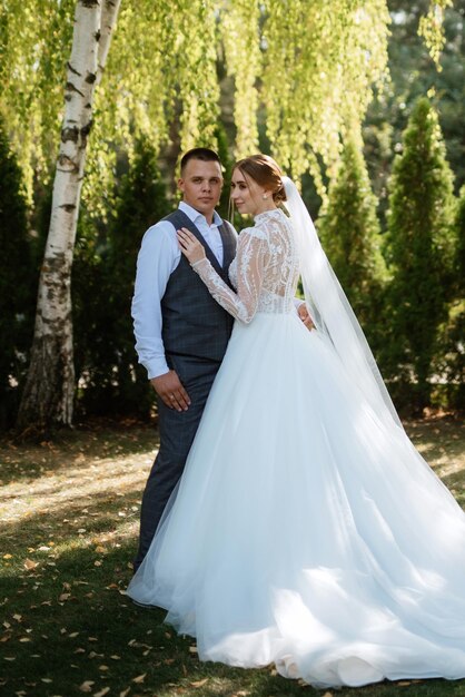 Young couple the groom in a plaid suit and the bride in a chic white dress