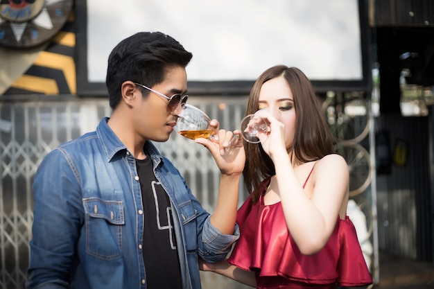 Young couple hand holding whiskey in party.