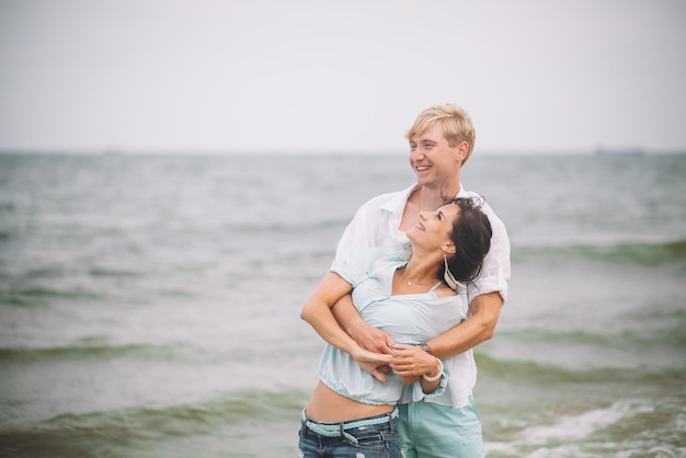 Young couple have fun on summer day at the beach