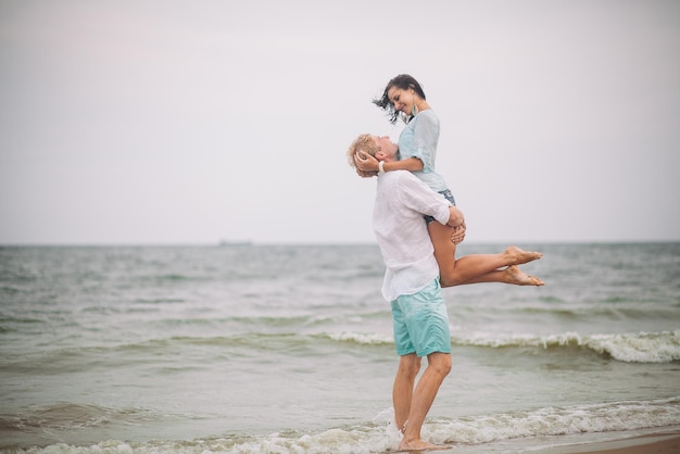 Young couple have fun on summer day at the beach