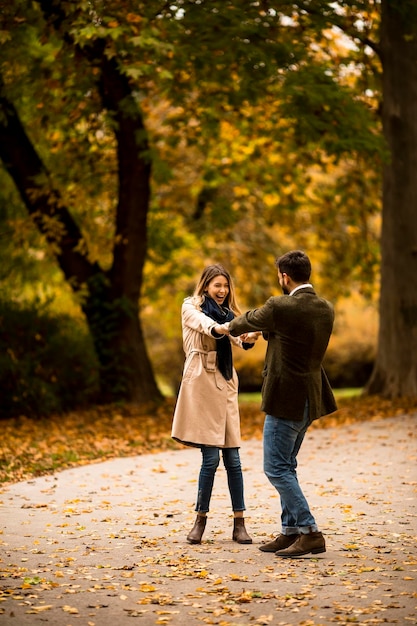 Young couple having fun in the autumn park