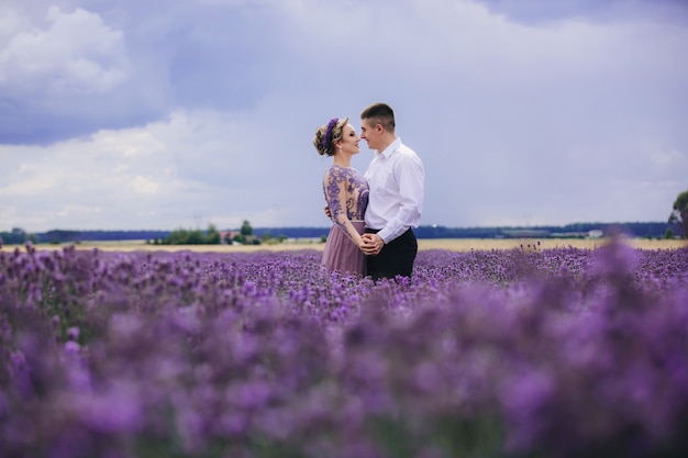 Young couple having fun in a lavender field