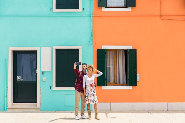  young couple having fun while visiting Venice - Tourists travelling in Italy and sightseeing the most relevant landmarks of Venezia - Concepts about lifestyle, travel, tourism