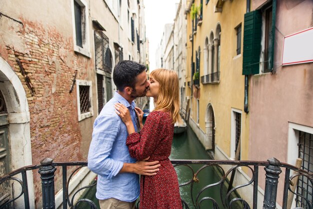 young couple having fun while visiting Venice - Tourists travelling in Italy and sightseeing the most relevant landmarks of Venezia - Concepts about lifestyle, travel, tourism