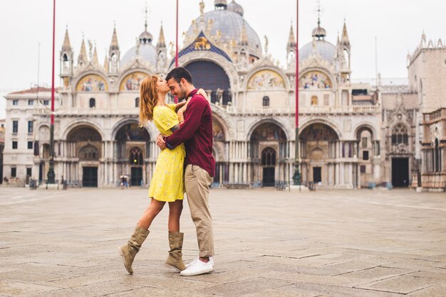 young couple having fun while visiting Venice - Tourists travelling in Italy and sightseeing the most relevant landmarks of Venezia - Concepts about lifestyle, travel, tourism
