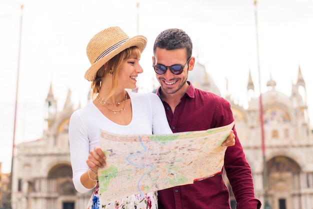 young couple having fun while visiting Venice - Tourists travelling in Italy and sightseeing the most relevant landmarks of Venezia - Concepts about lifestyle, travel, tourism