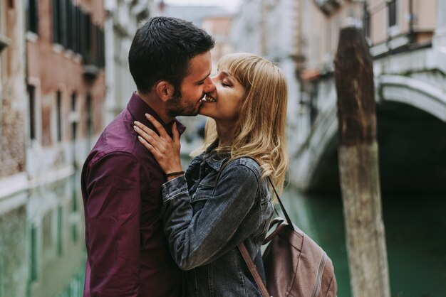 young couple having fun while visiting Venice - Tourists travelling in Italy and sightseeing the most relevant landmarks of Venezia - Concepts about lifestyle, travel, tourism