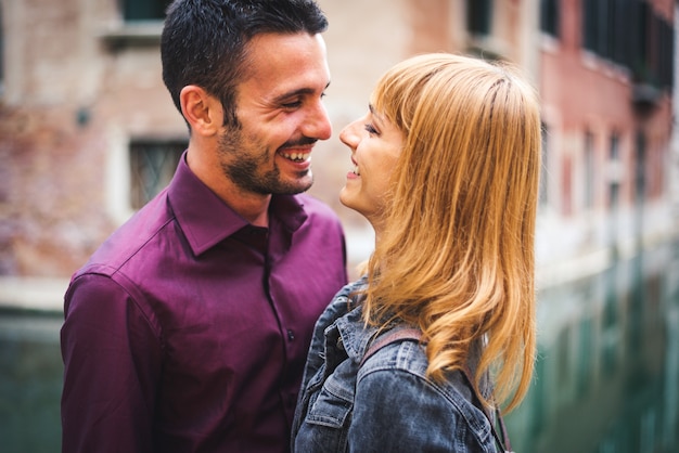 young couple having fun while visiting Venice - Tourists travelling in Italy and sightseeing the most relevant landmarks of Venezia - Concepts about lifestyle, travel, tourism