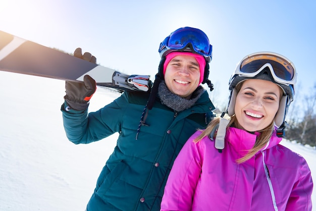 Young couple having fun while winter skiing. High quality photo