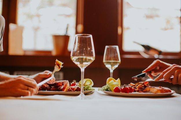 Young couple having lunch with white wine in the restaurant