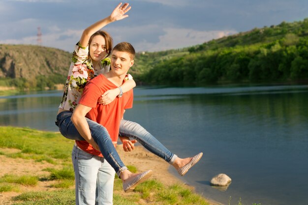 Young couple having a piggy back ride