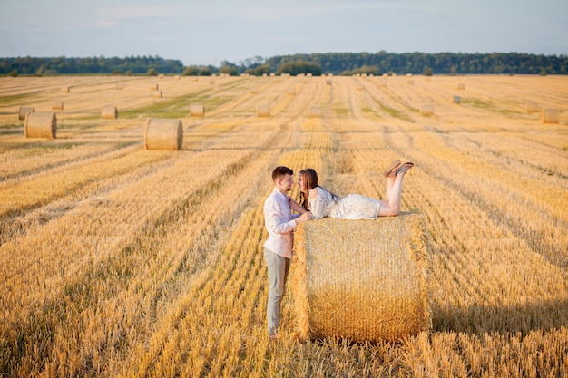 Young couple on a hay field