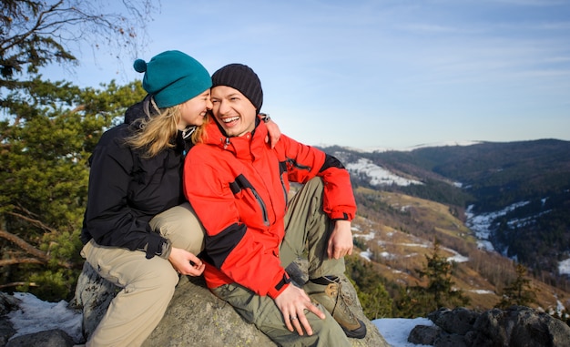 Young couple of hikers on top of mountain