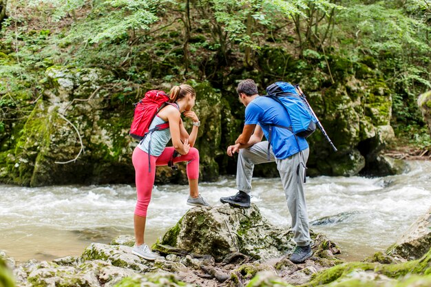 Young couple hiking by the river